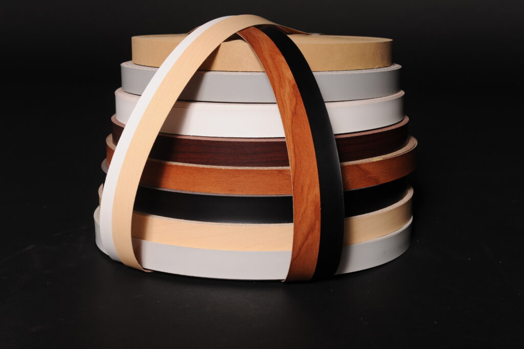 A stack of polyester and wood veneer rolls